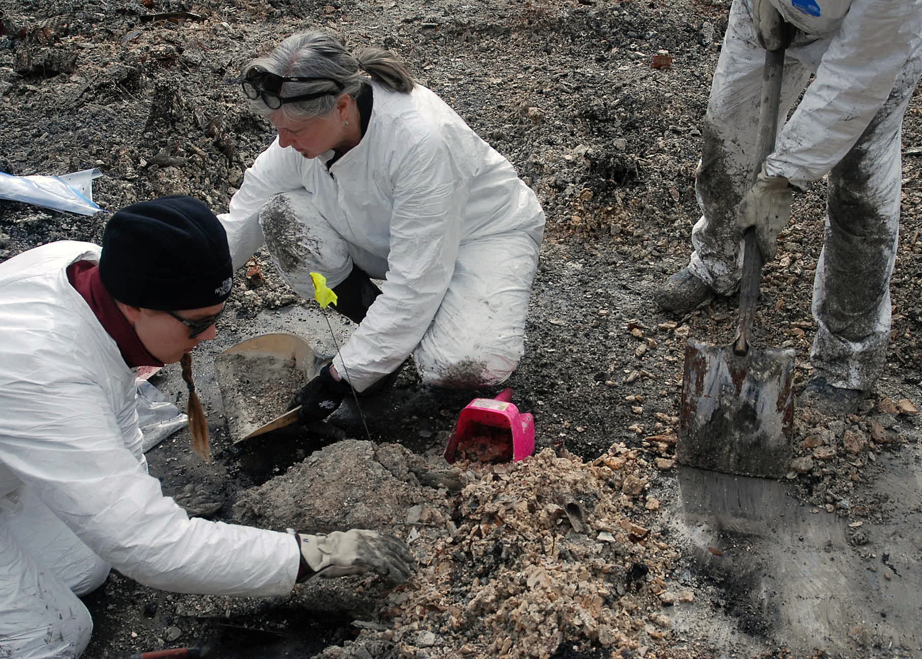 Sacramento District's Joanne Goodsell, center, and Geneva Kraus, pick through burned debris while helping search for cremains at the site of the Camp Fire in Paradise, California, in February 2019.